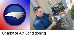 Charlotte, North Carolina - an HVAC contractor servicing an air conditioner