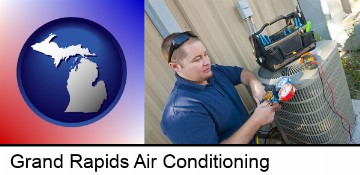 an HVAC contractor servicing an air conditioner in Grand Rapids, MI