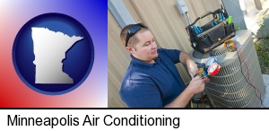 Minneapolis, Minnesota - an HVAC contractor servicing an air conditioner