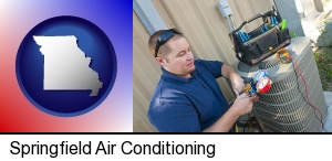 Springfield, Missouri - an HVAC contractor servicing an air conditioner