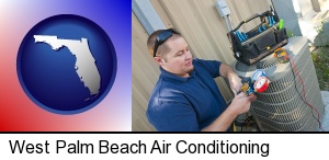 West Palm Beach, Florida - an HVAC contractor servicing an air conditioner