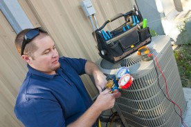 an HVAC contractor servicing an air conditioner