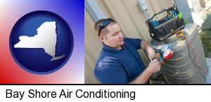 an HVAC contractor servicing an air conditioner in Bay Shore, NY