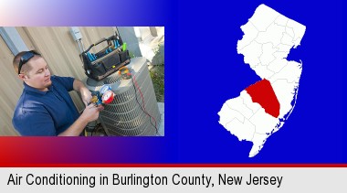 an HVAC contractor servicing an air conditioner; Burlington County highlighted in red on a map
